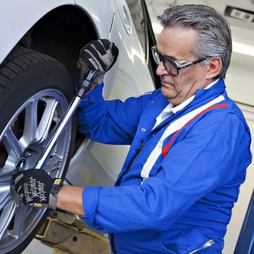Qualified mechanic making repairs at an MOT garage near me.