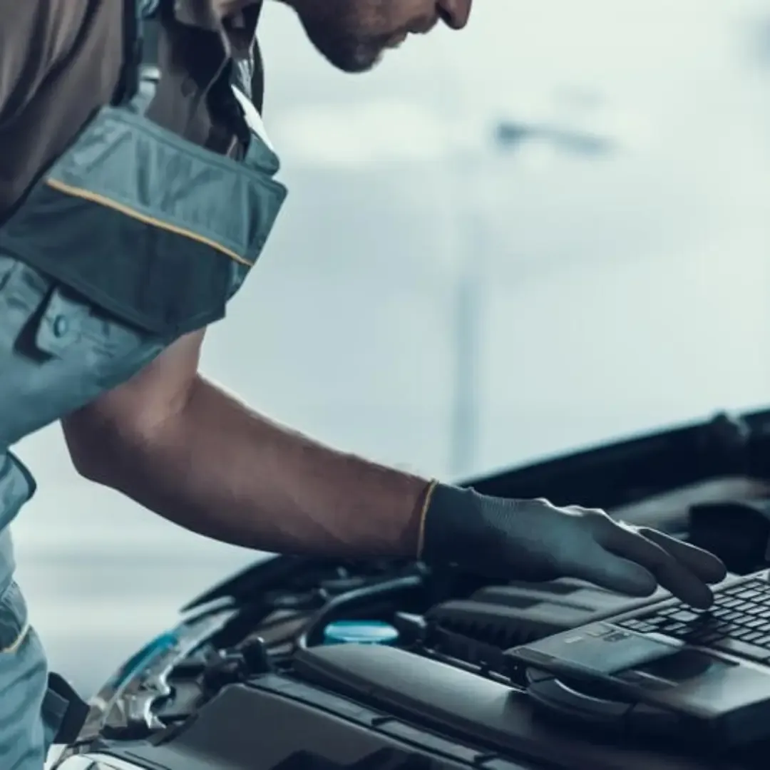 Qualified mechanic running tests on an engine during an DVLA MOT test in Liverpool, Merseyside.